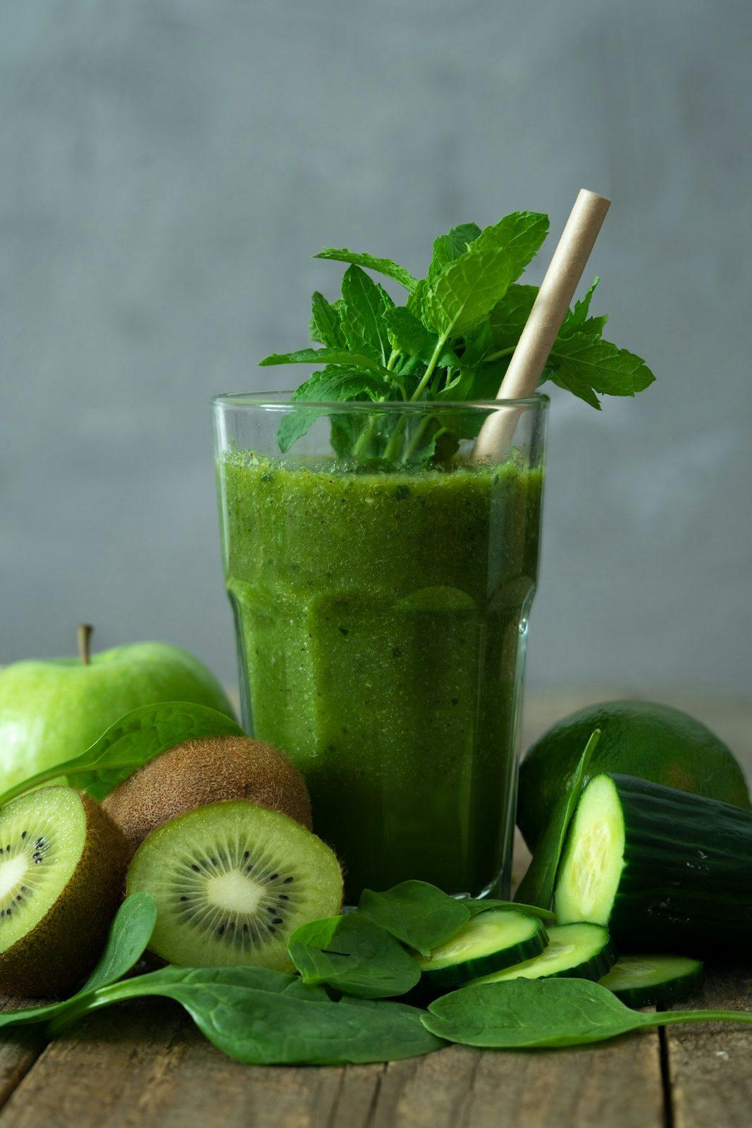 A green Moringa wellness smoothie in a glass